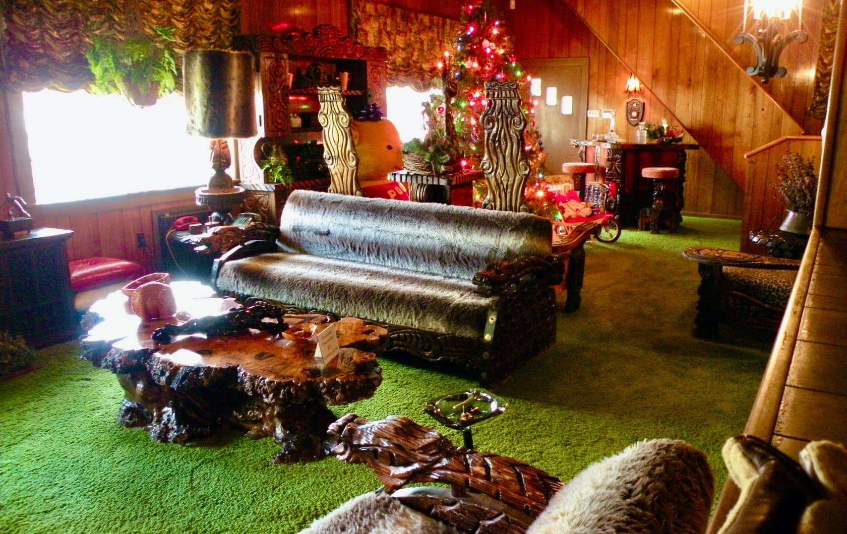 Living room with odd furniture and green carpet
