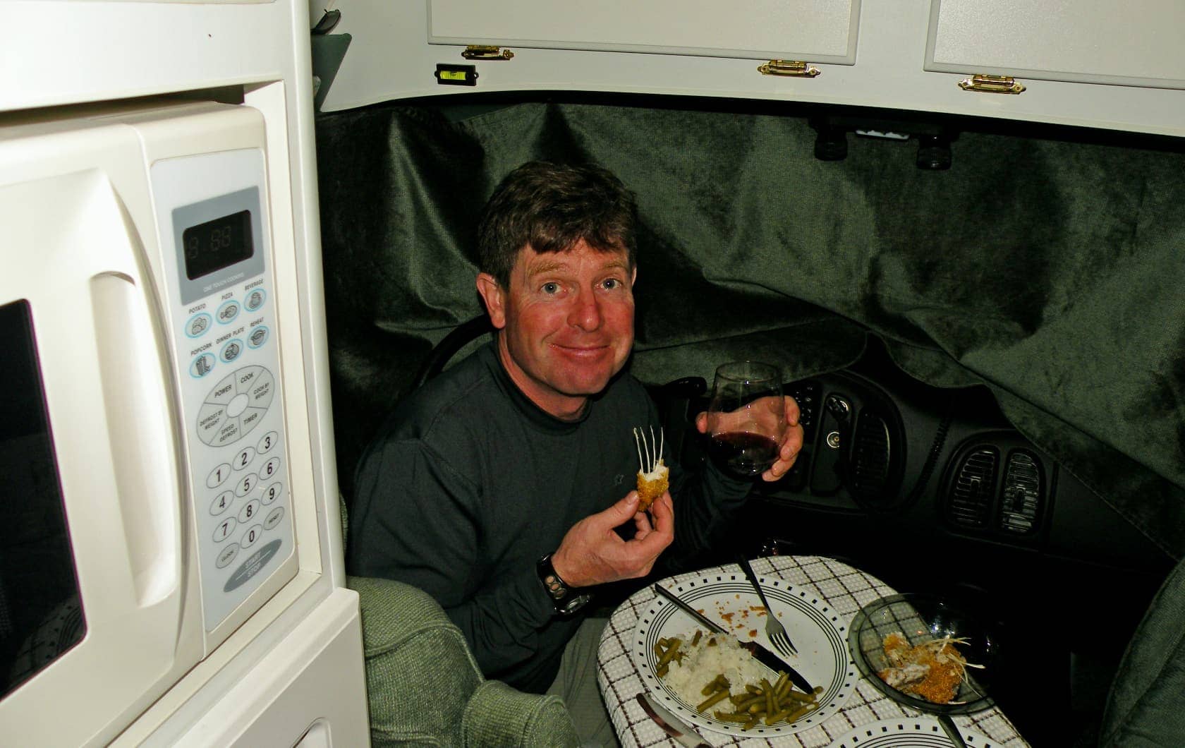 Man eating dinner in RV in Montana