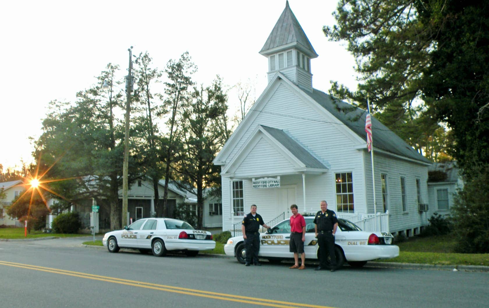 Man with two police officers in front of church