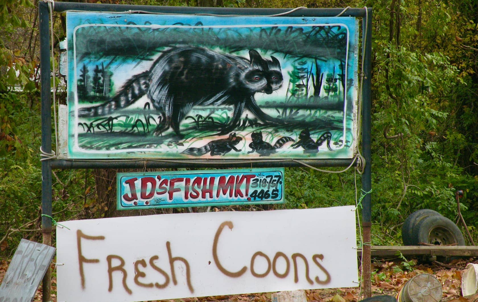 Sign offering fresh racoons for sale