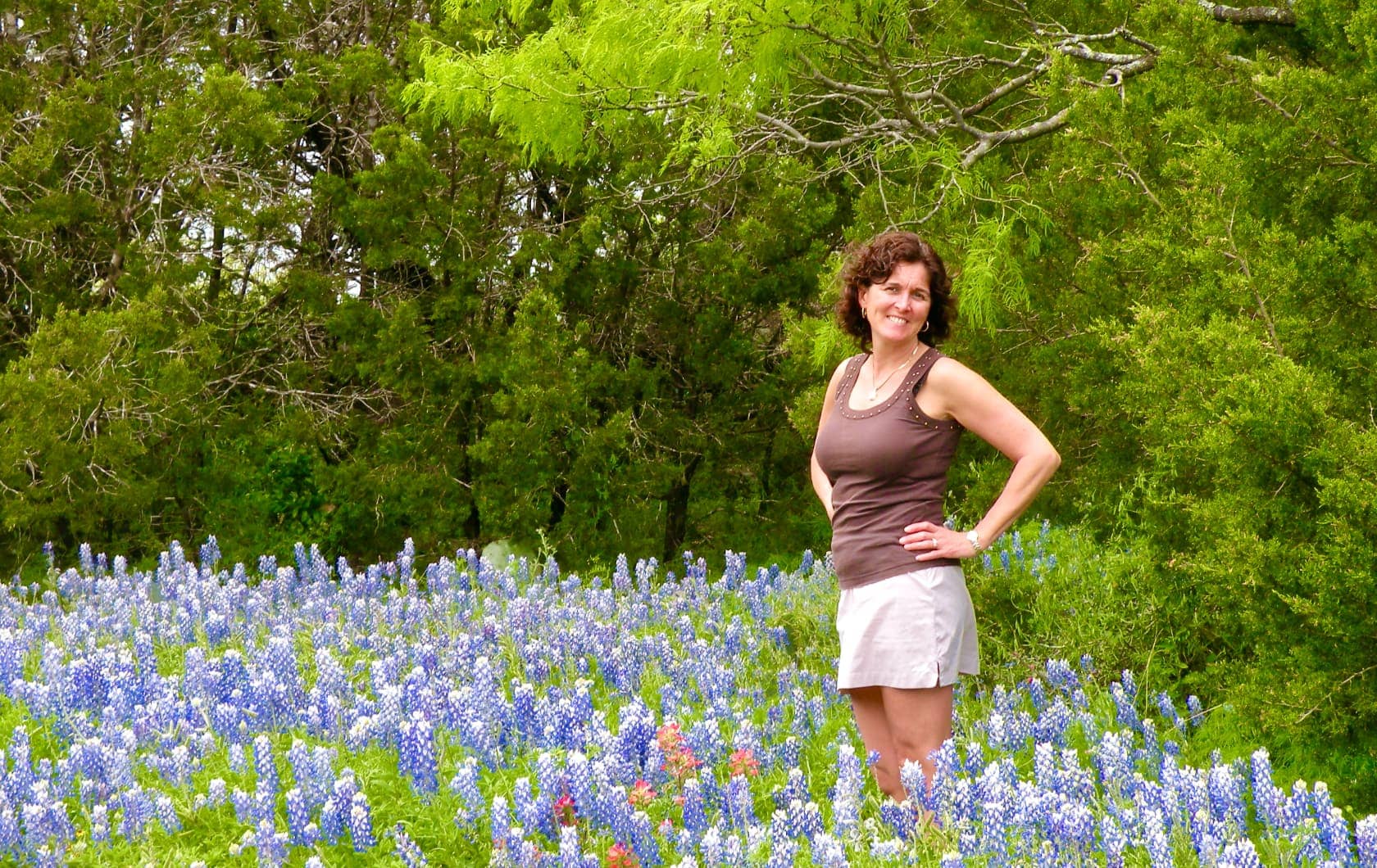 Woman standing amongst blue flowers in Texas
