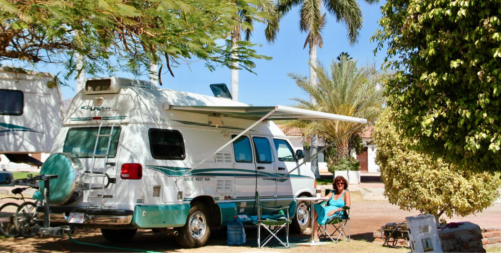 Woman with camper van at camp site in Mexico