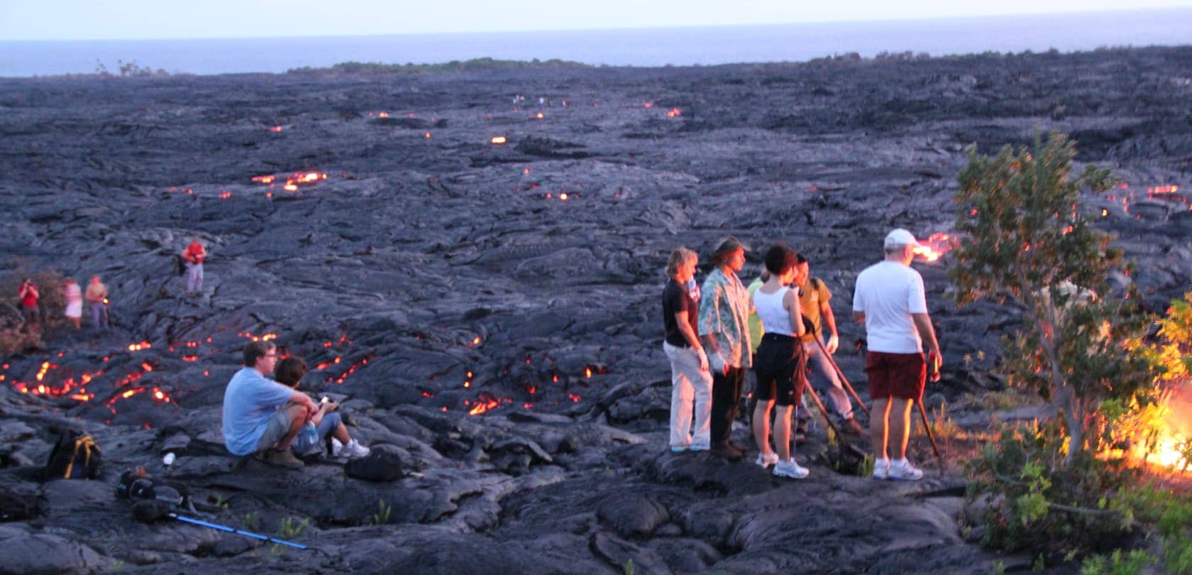 People amongst active lava field in Hawai'i
