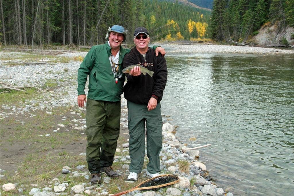 Two men fishing on a mountain river