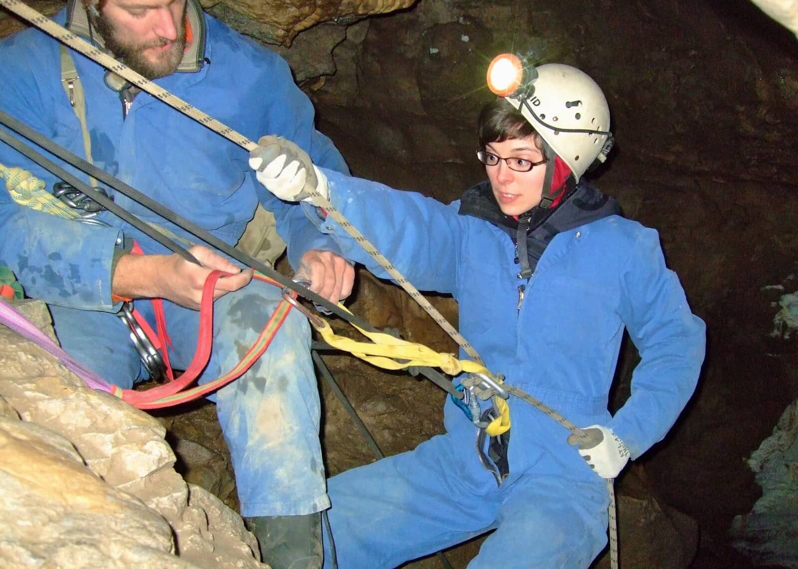 Woman rappelling inside of Rat's Nest Cave