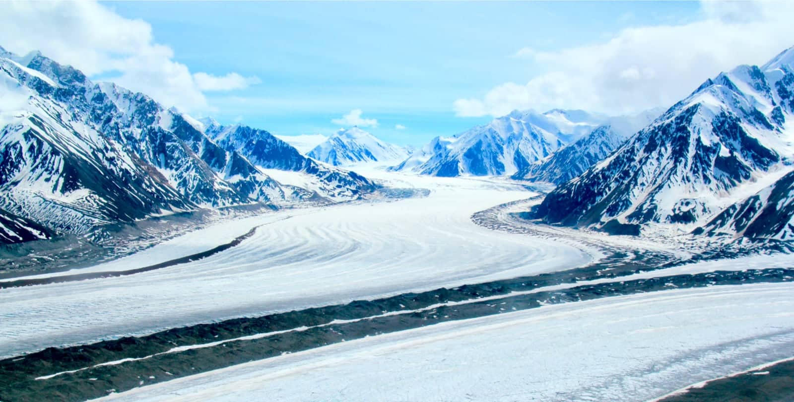 Snow covered peaks and blue skies in Yukon