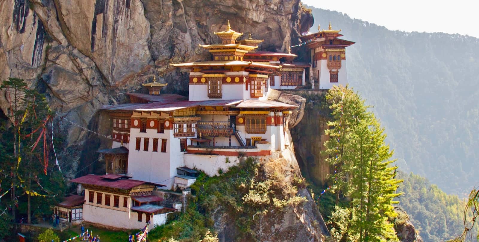 Red, gold, and white template on cliff side in Bhutan