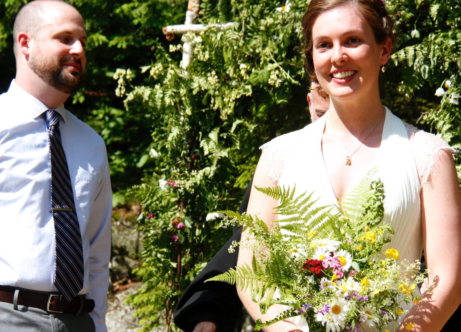 Woman and man partaking in wedding ceremony