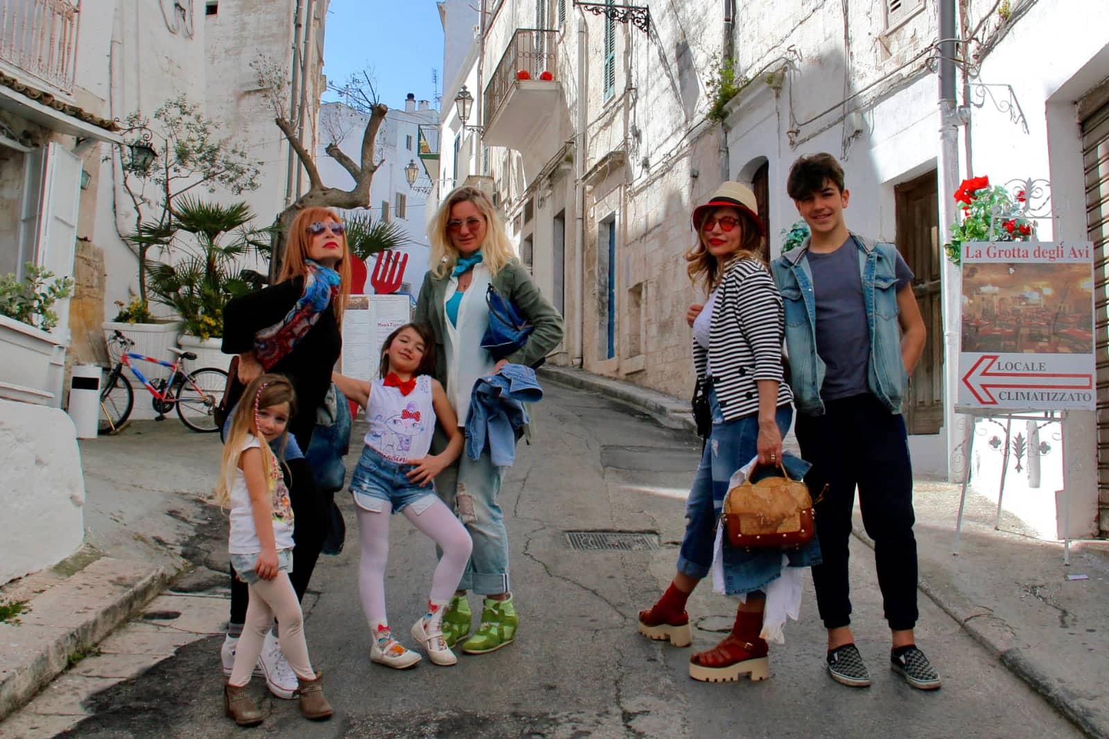 Italian family proudly showing off their boots on street