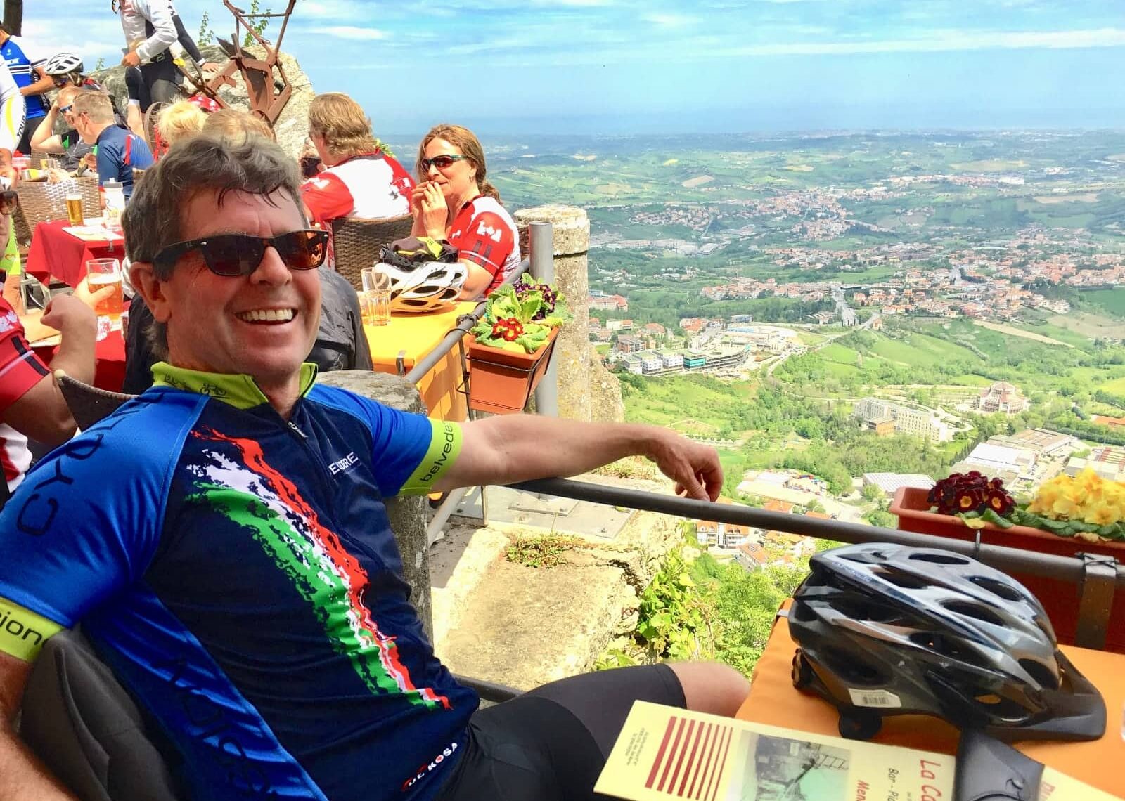 Man smiling while enjoying view of Italian countryside