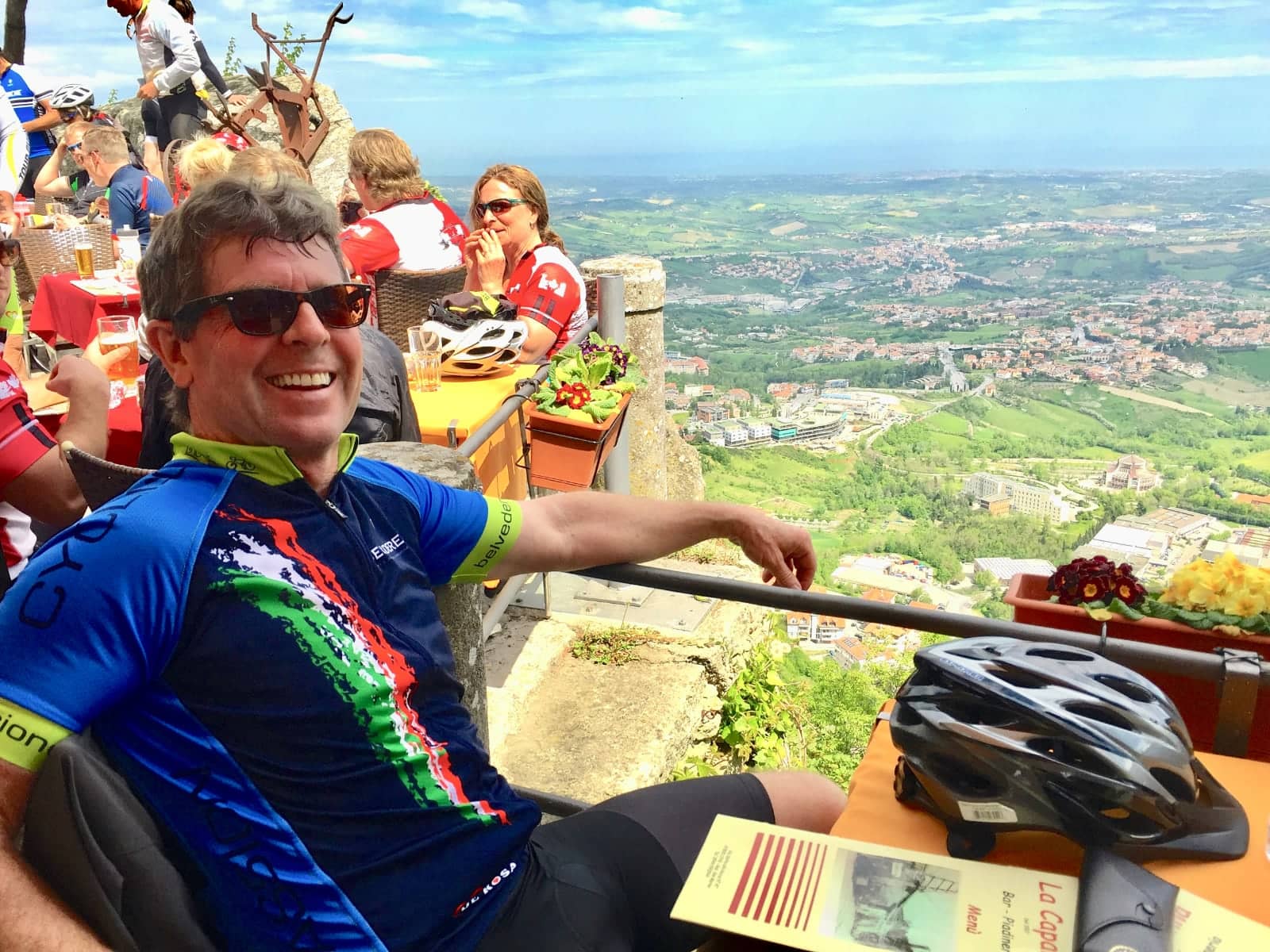 Man smiling while enjoying view of Italian countryside