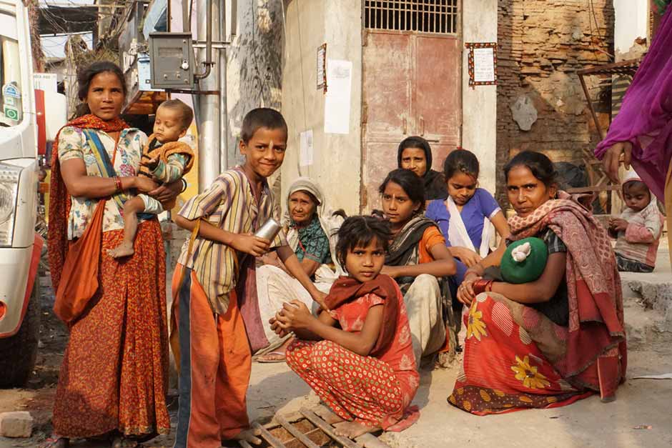 A family sitting on the streets of Varanasi, India