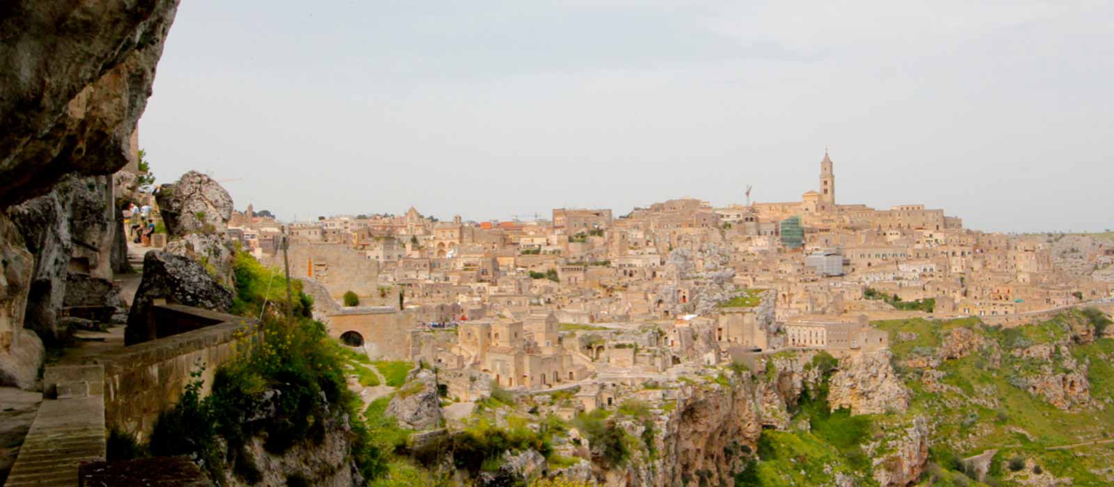 Mountain cliffs, walkway, and old city