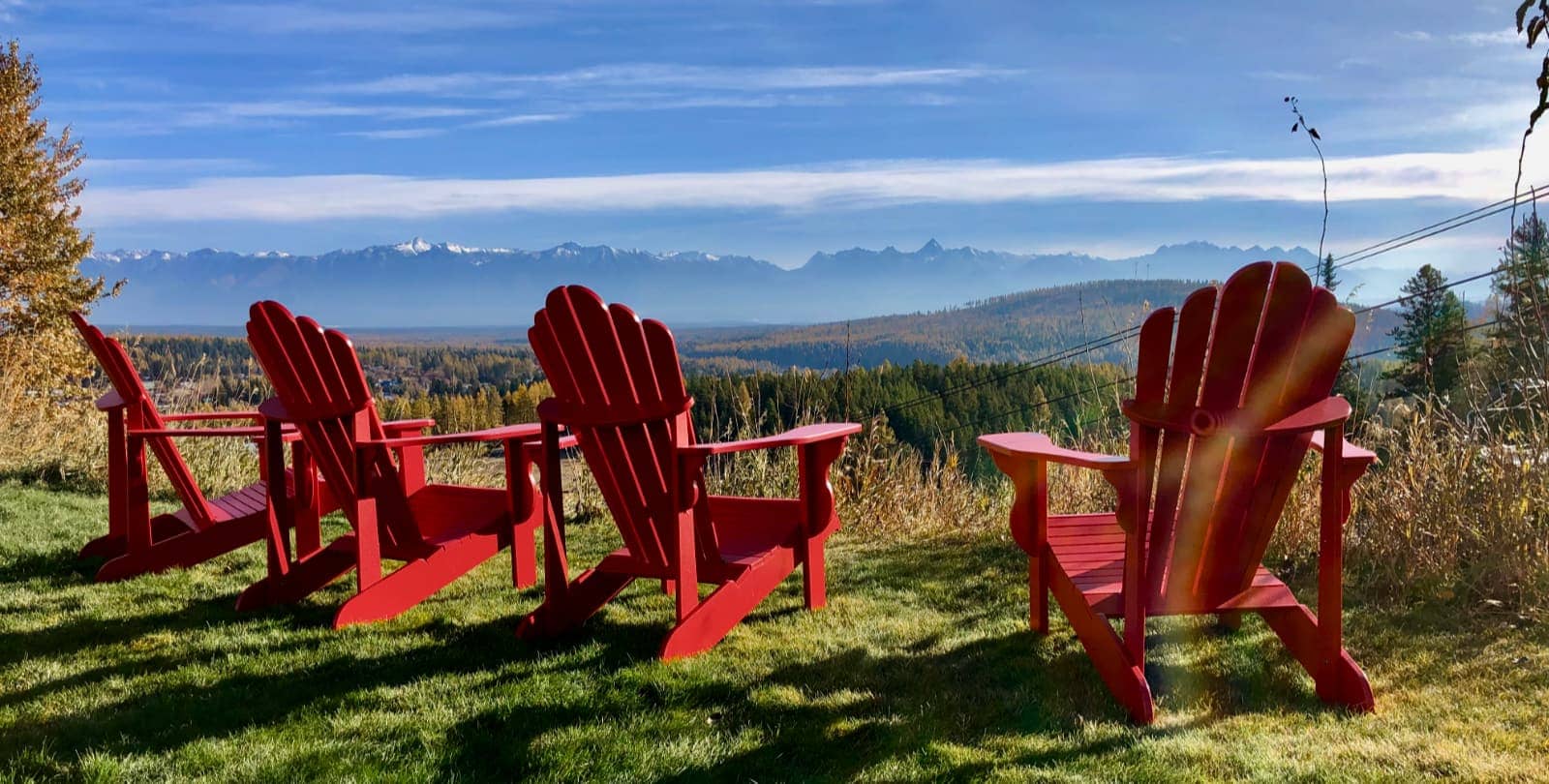 Red adarondak chairs against blue sky