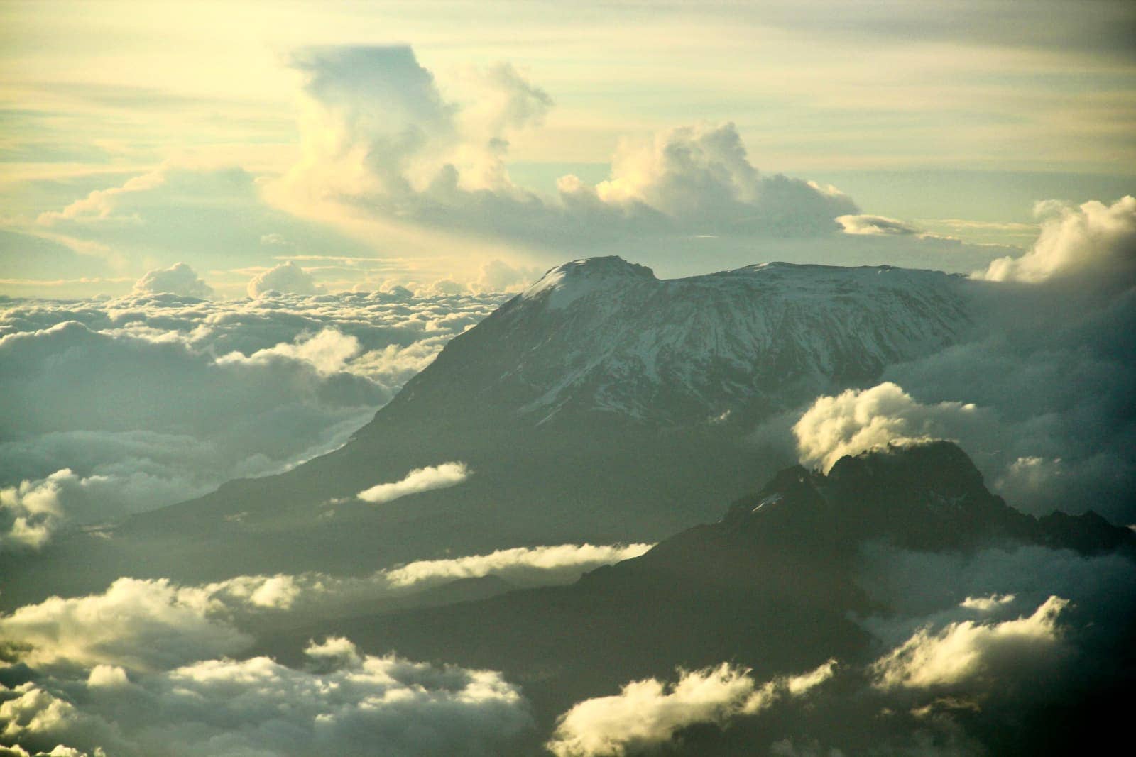 Aerial view of clouds and snow covered mountains