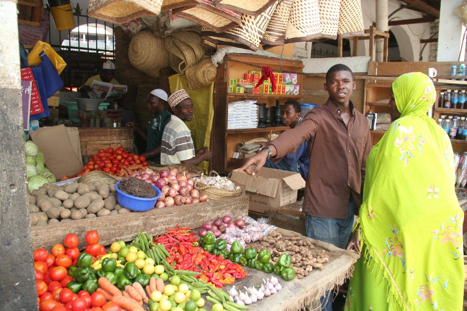 African man pointing at fresh vegetables at market