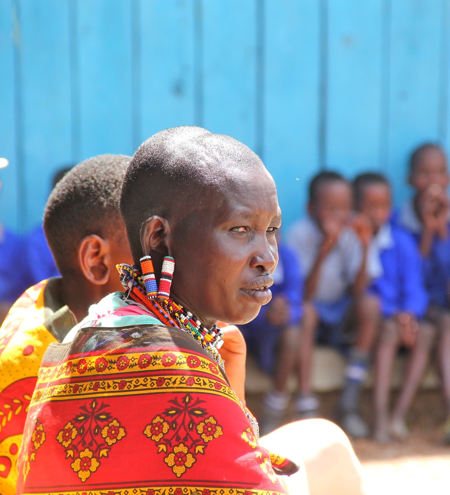 African woman in red dress looking at camera