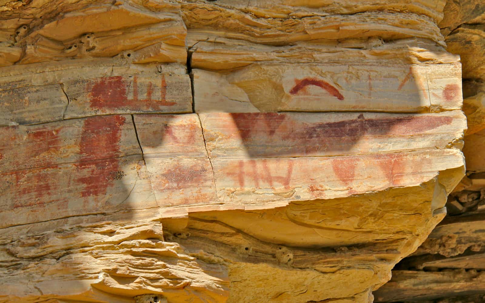 Ancient rock art painted in red on rock face