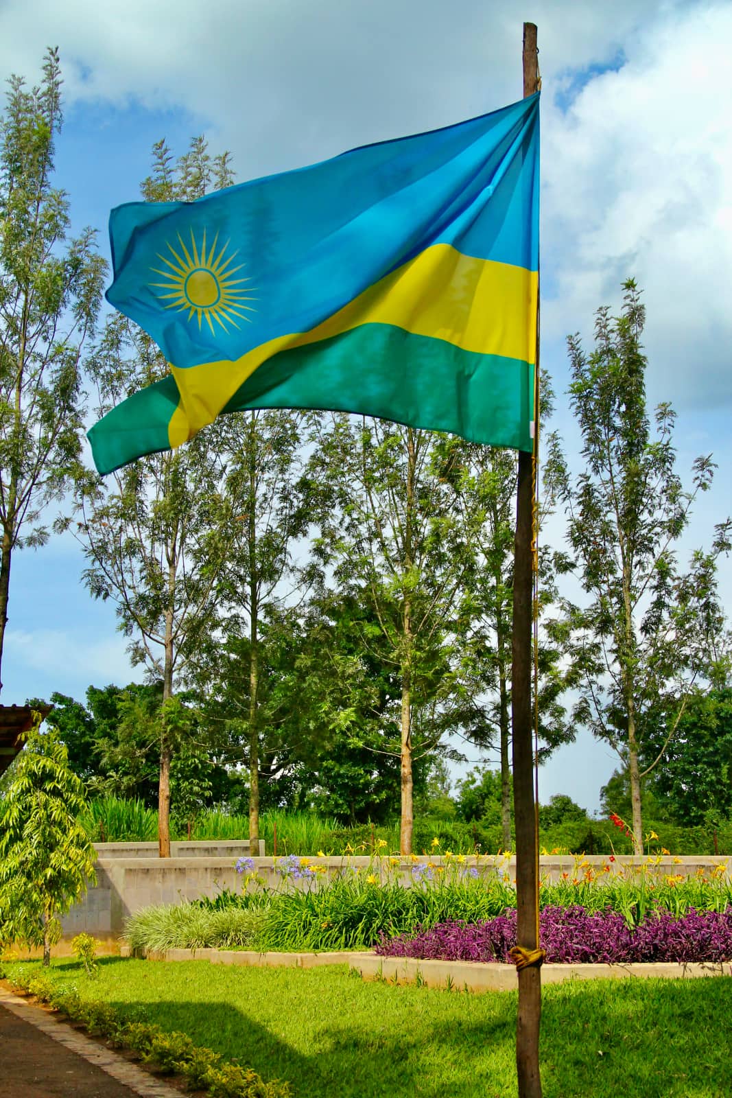 Blue, yellow and green Rwandan flag blowing in wind