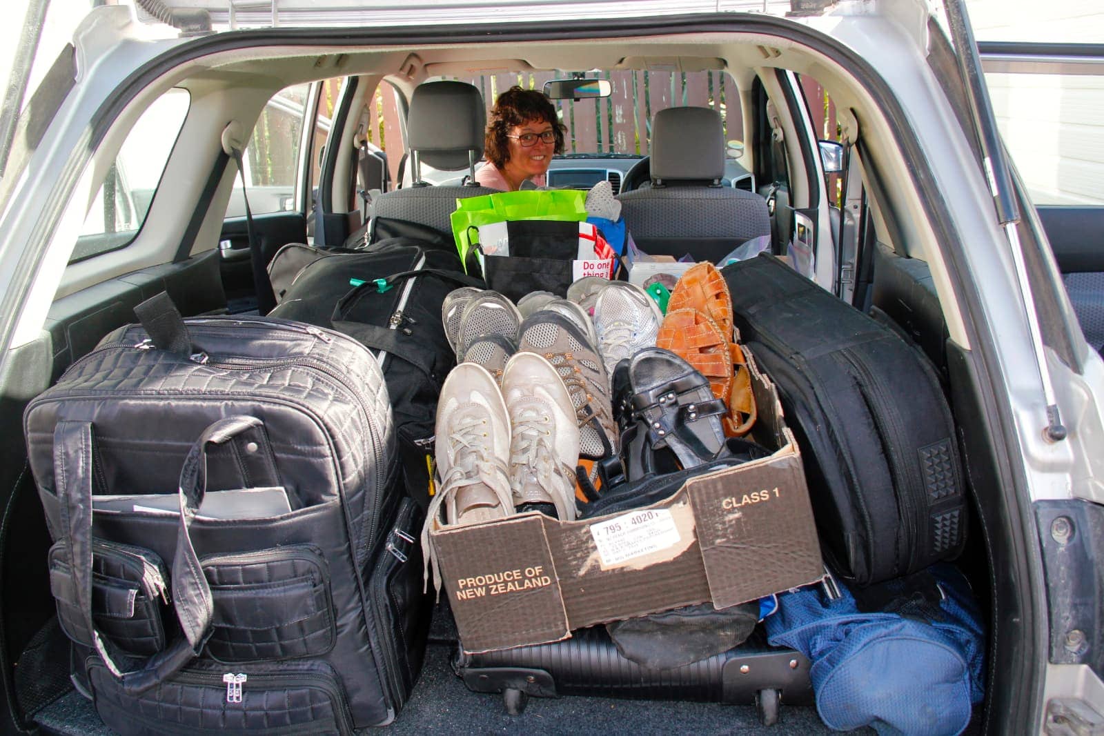 Car packed with gear and woman in front seat