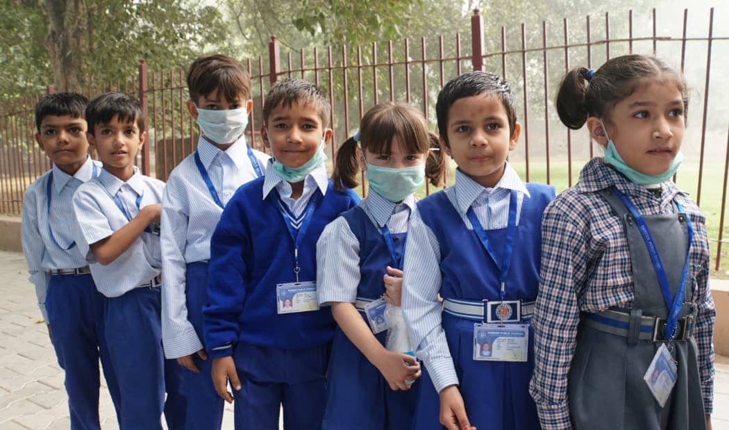 Children dressed in blue going to school