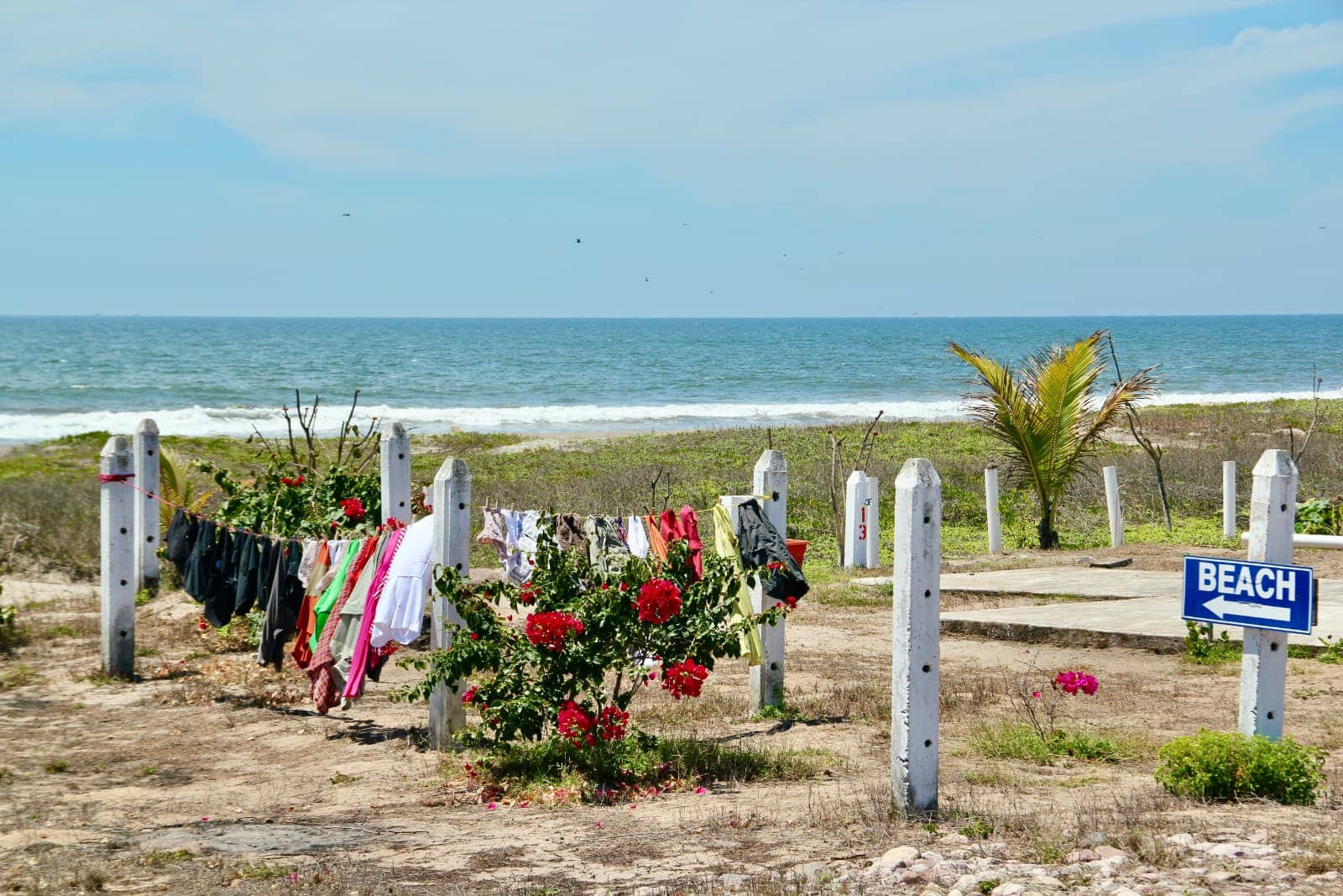 Clothes hanging to dry in foreground with ocean in background