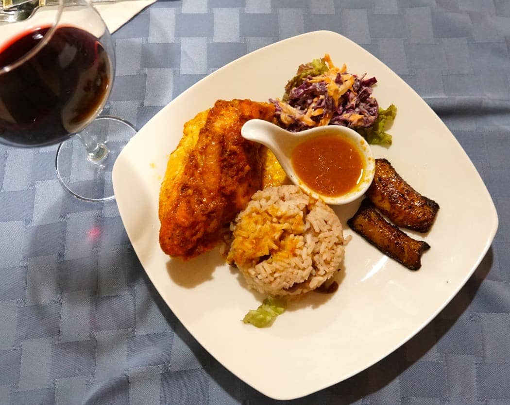 Colourful plate of local food and glass of wine