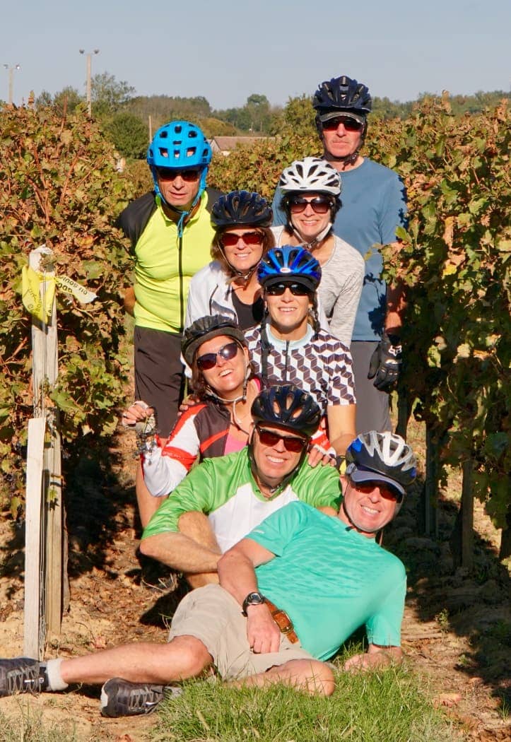 Cyclists posing in vineyard