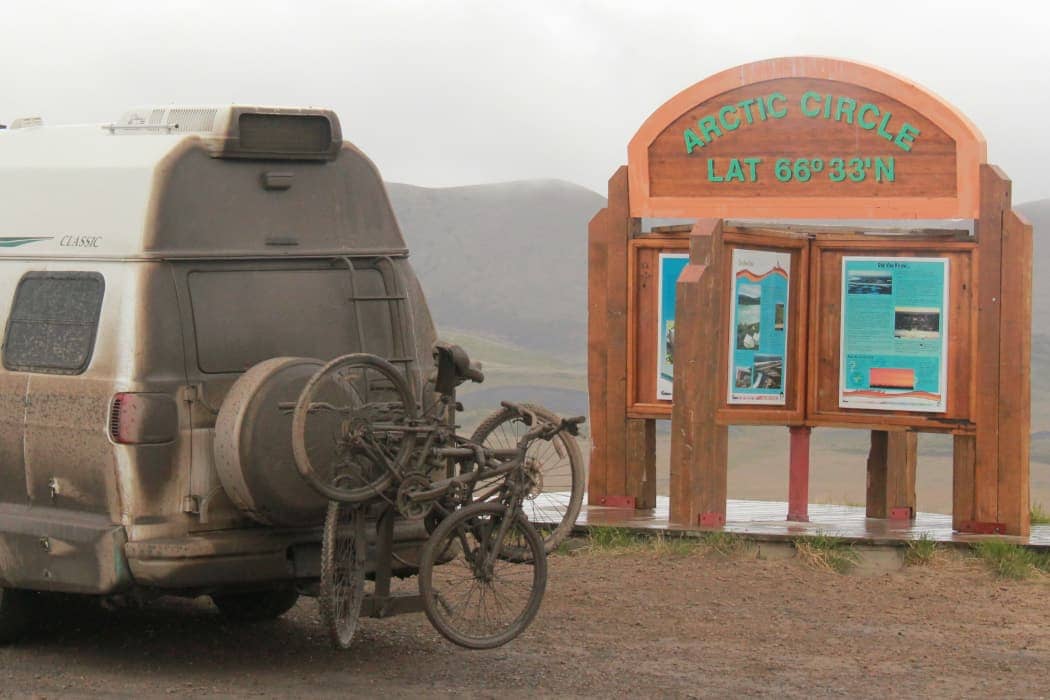 Dusty van with bikes and Arctic Circle sign