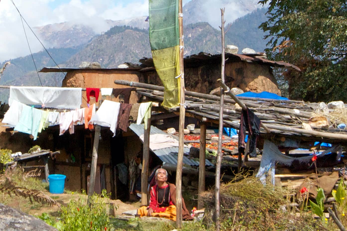 Elderly man sitting under wooden structure