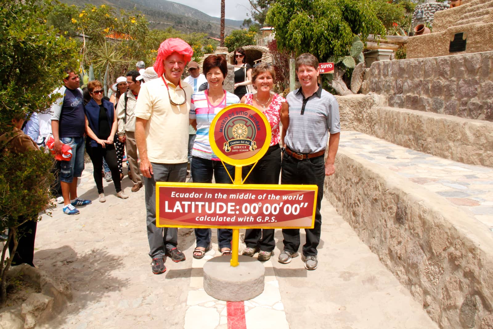 Four people standing on the equator