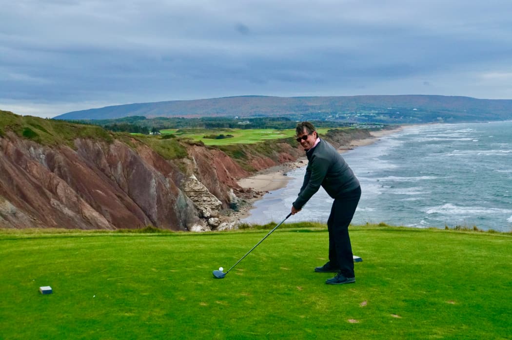 Man driving golf ball Cape Breton