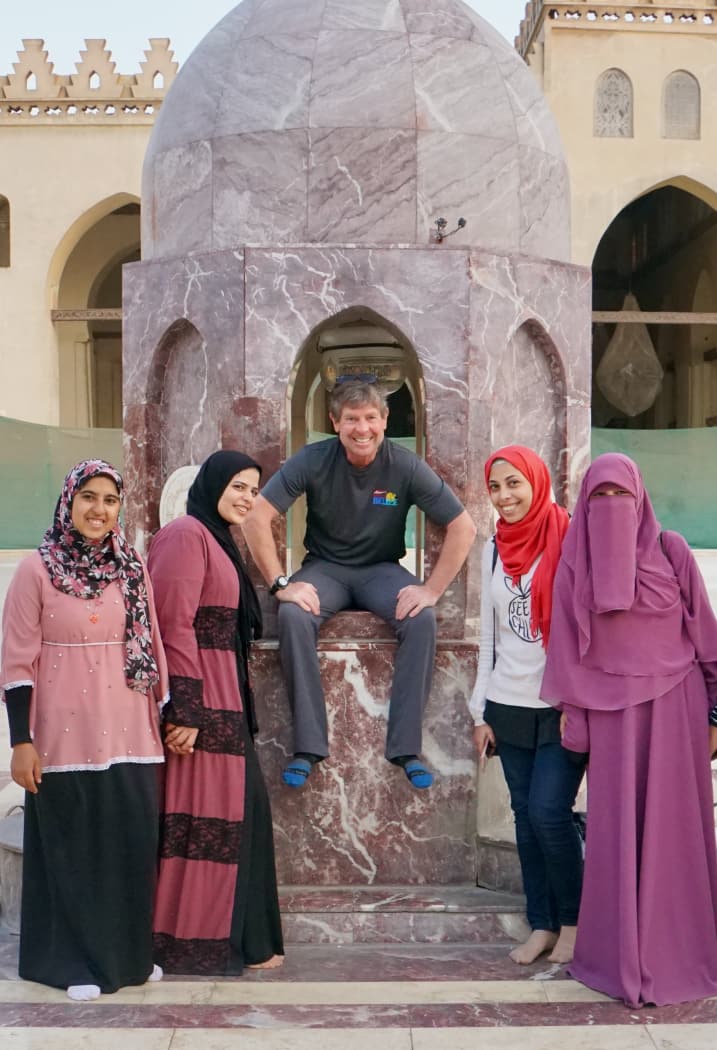 Gerry posing with local women in Cairo