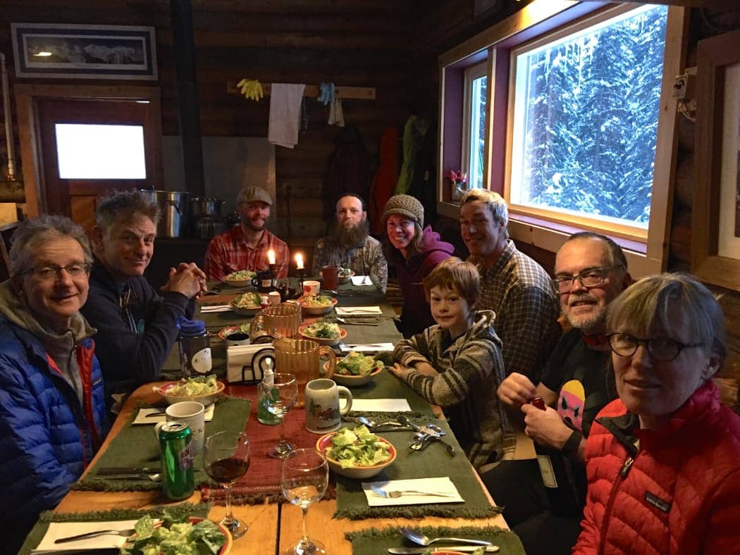 Group meal in mountain cabin