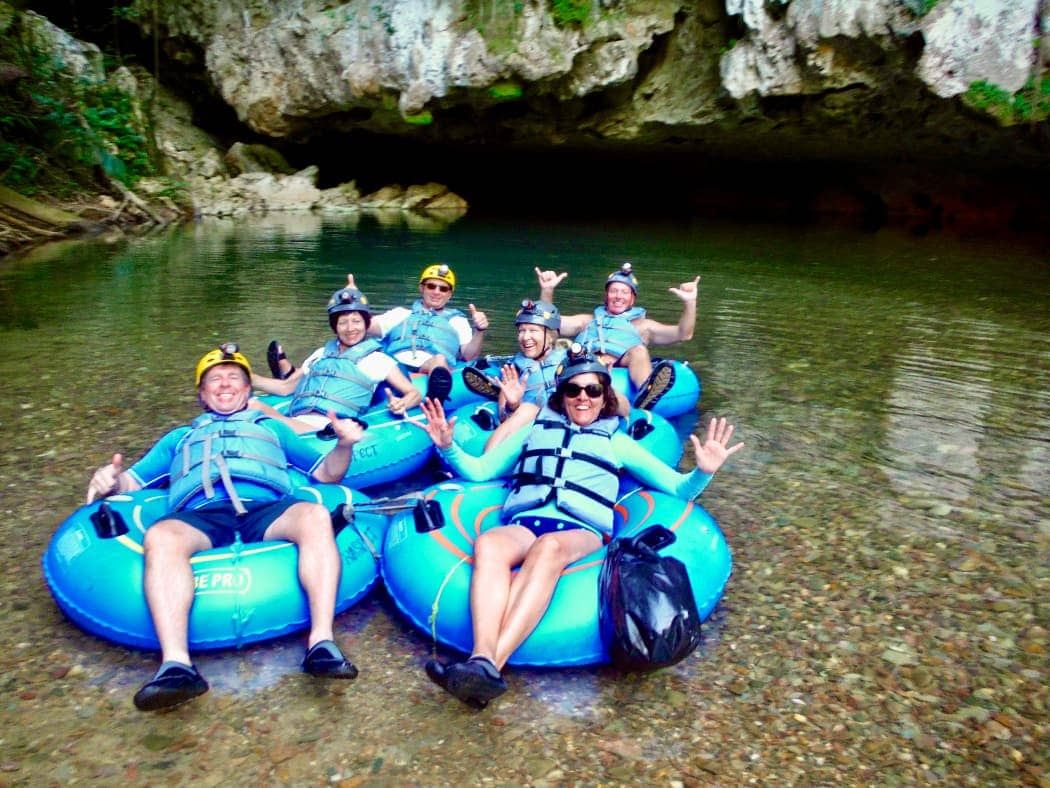 Group of people posing for photo on floating tubes