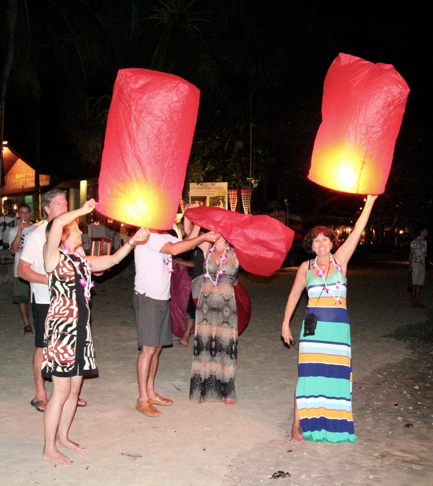 Group of people releasing Asian lanterns