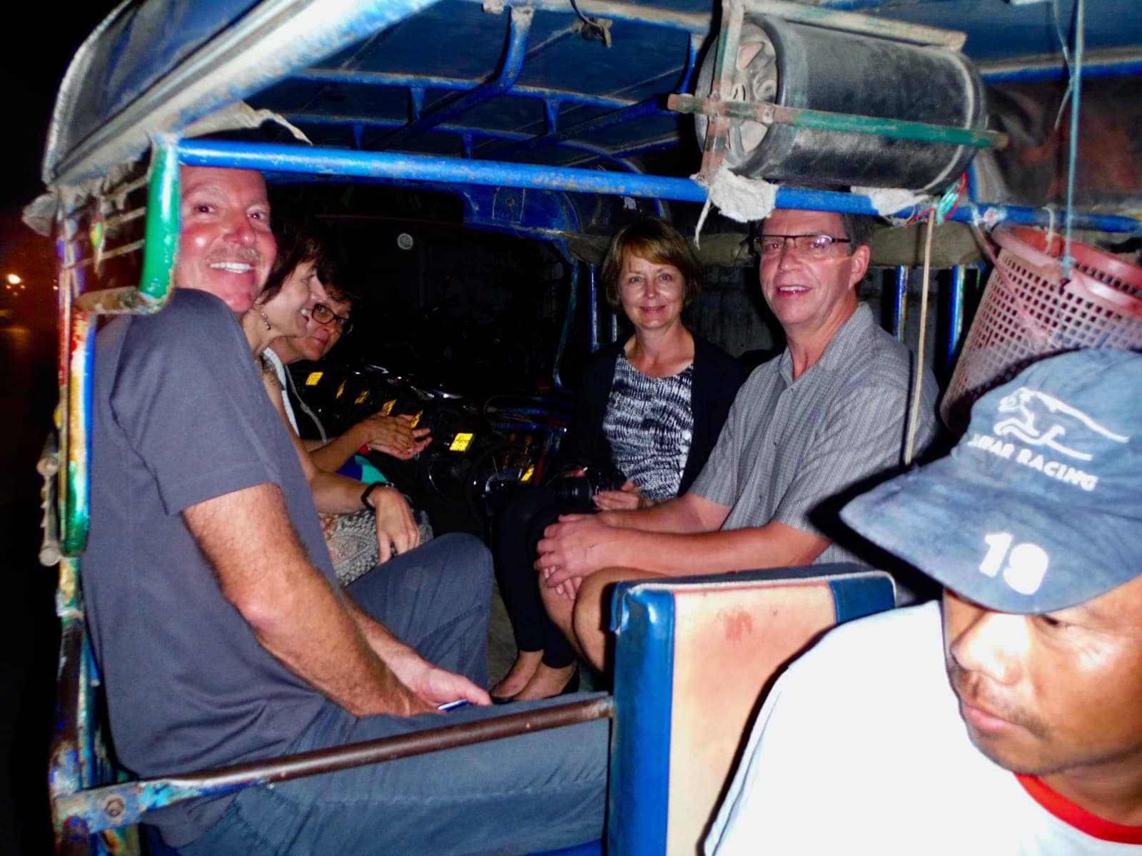 Group of people riding in tuk tuk