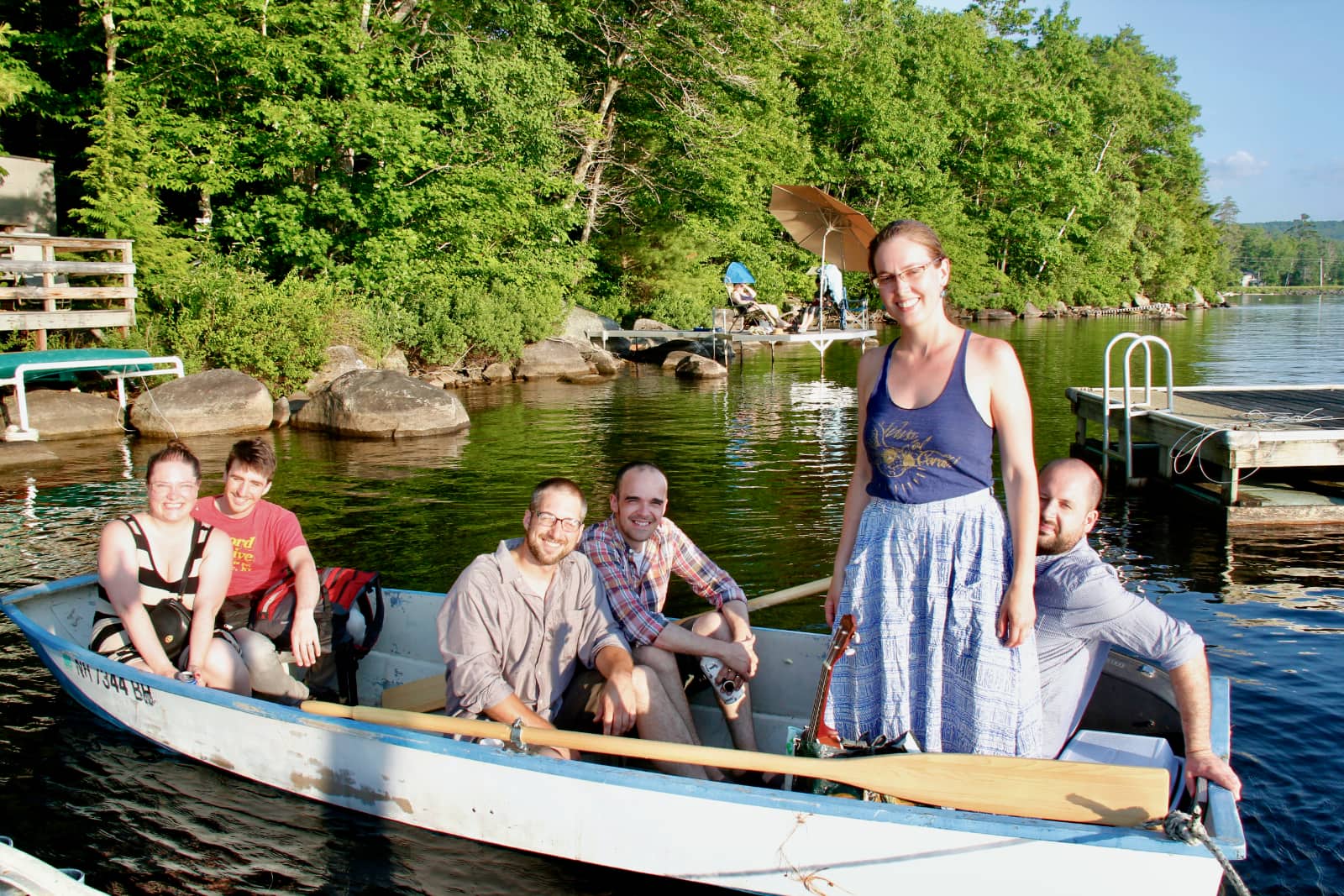 Group of people sitting in row boat