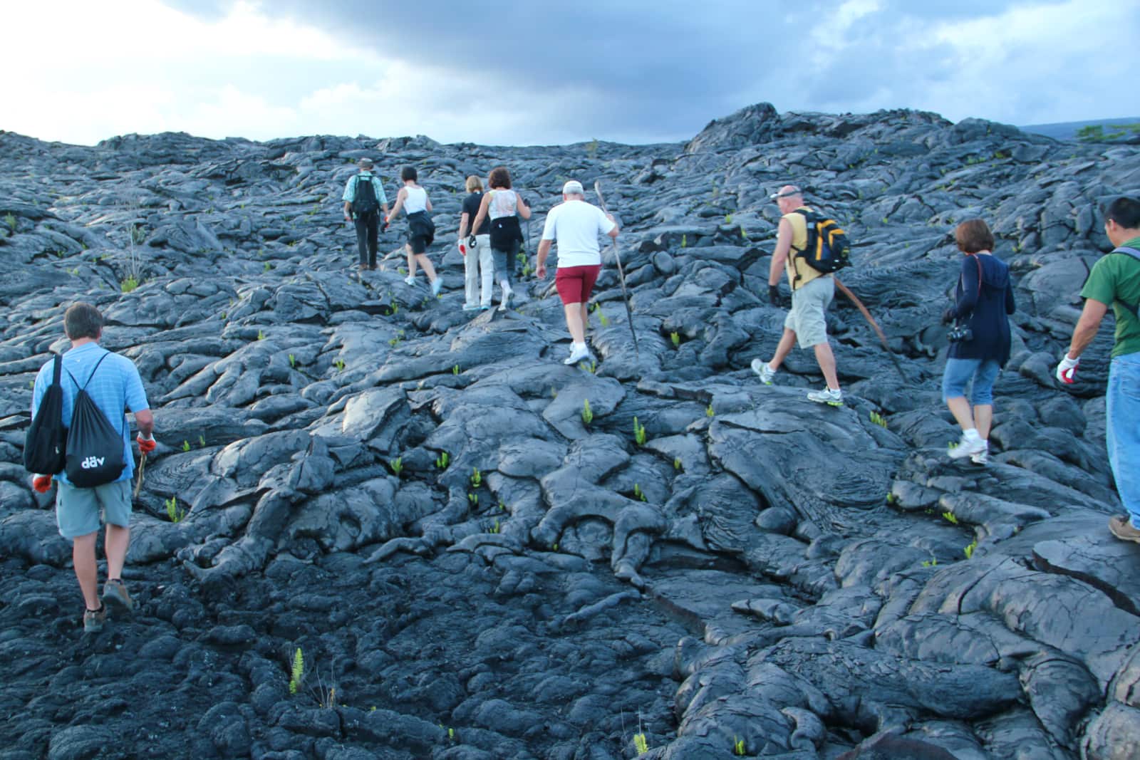 Group of people walking on lava in Hawaii