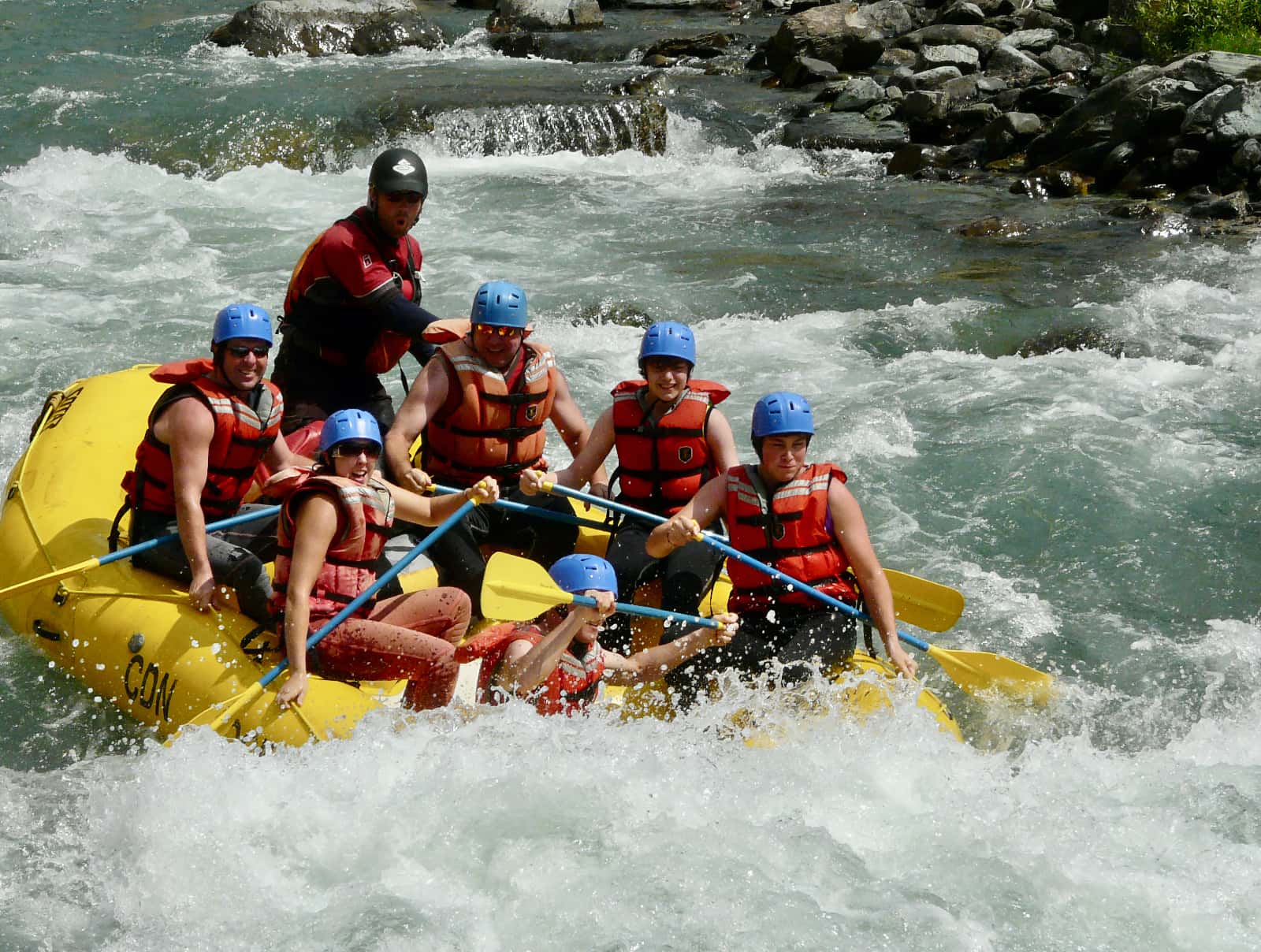 Group white water rafting down river