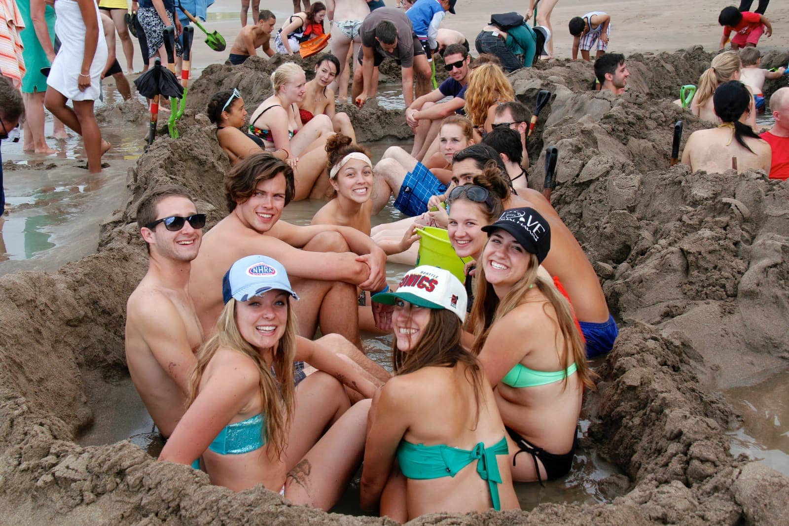 Groups of people enjoying warm waters at beach