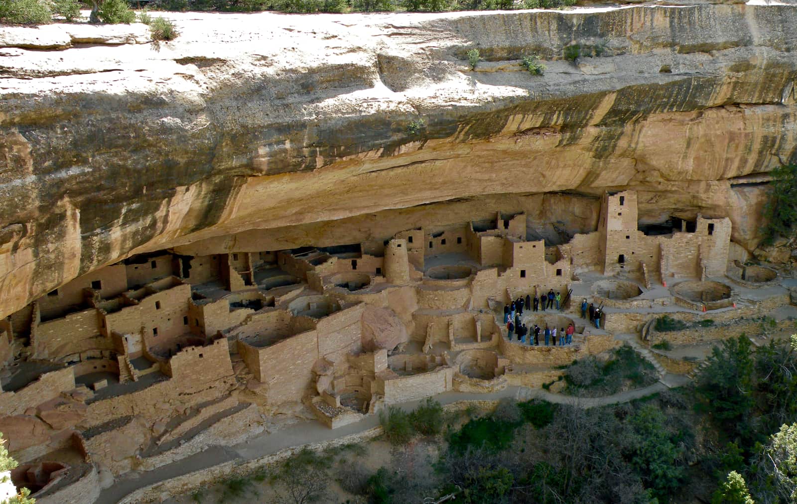 Indigenous stone village and group of people in background