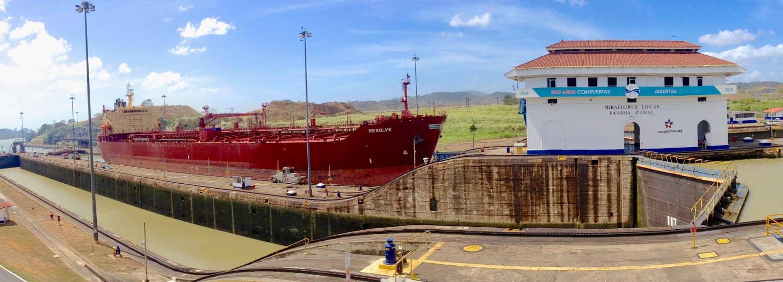 Large red ship passing through Panama Canal