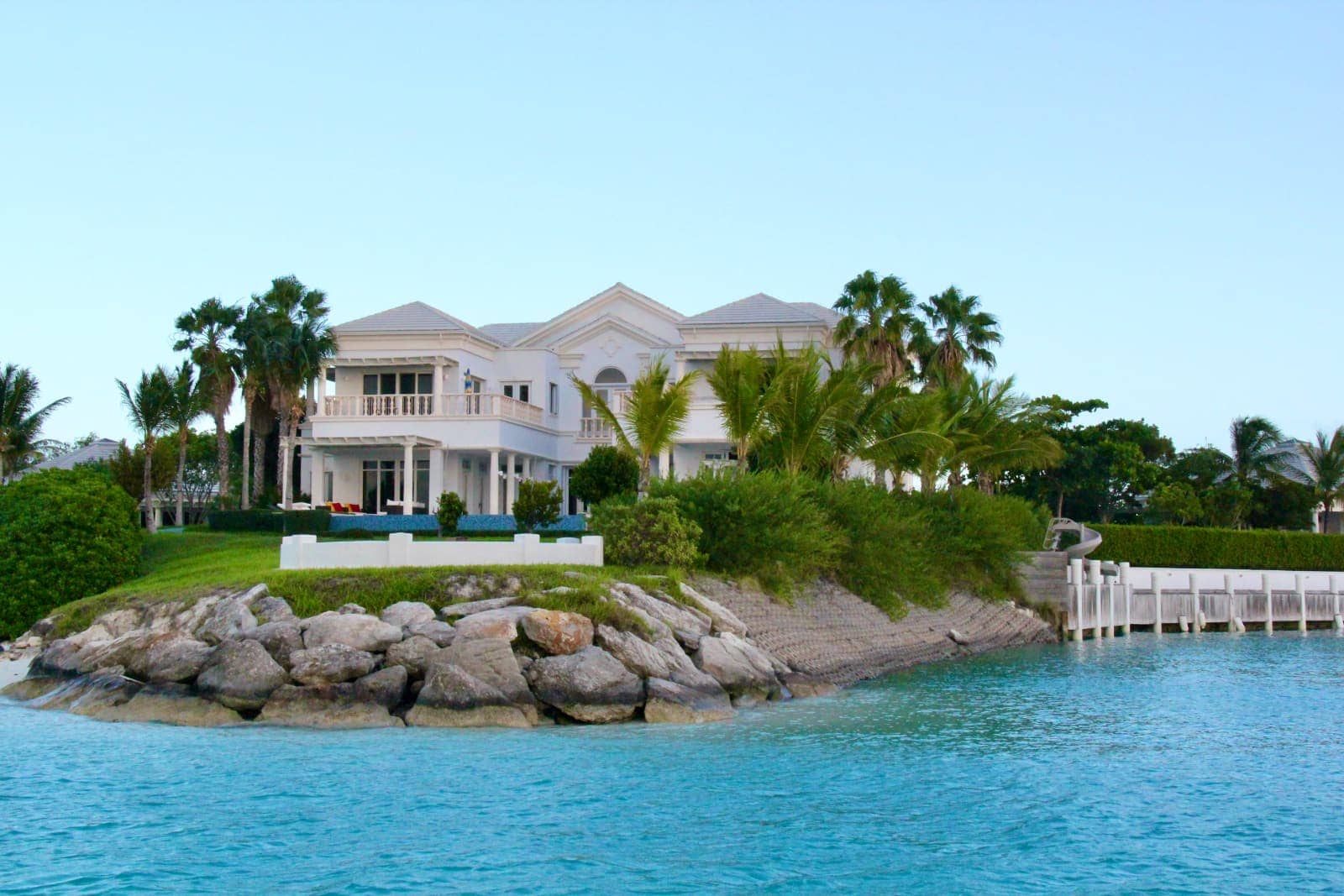 Large white house on shore of lagoon