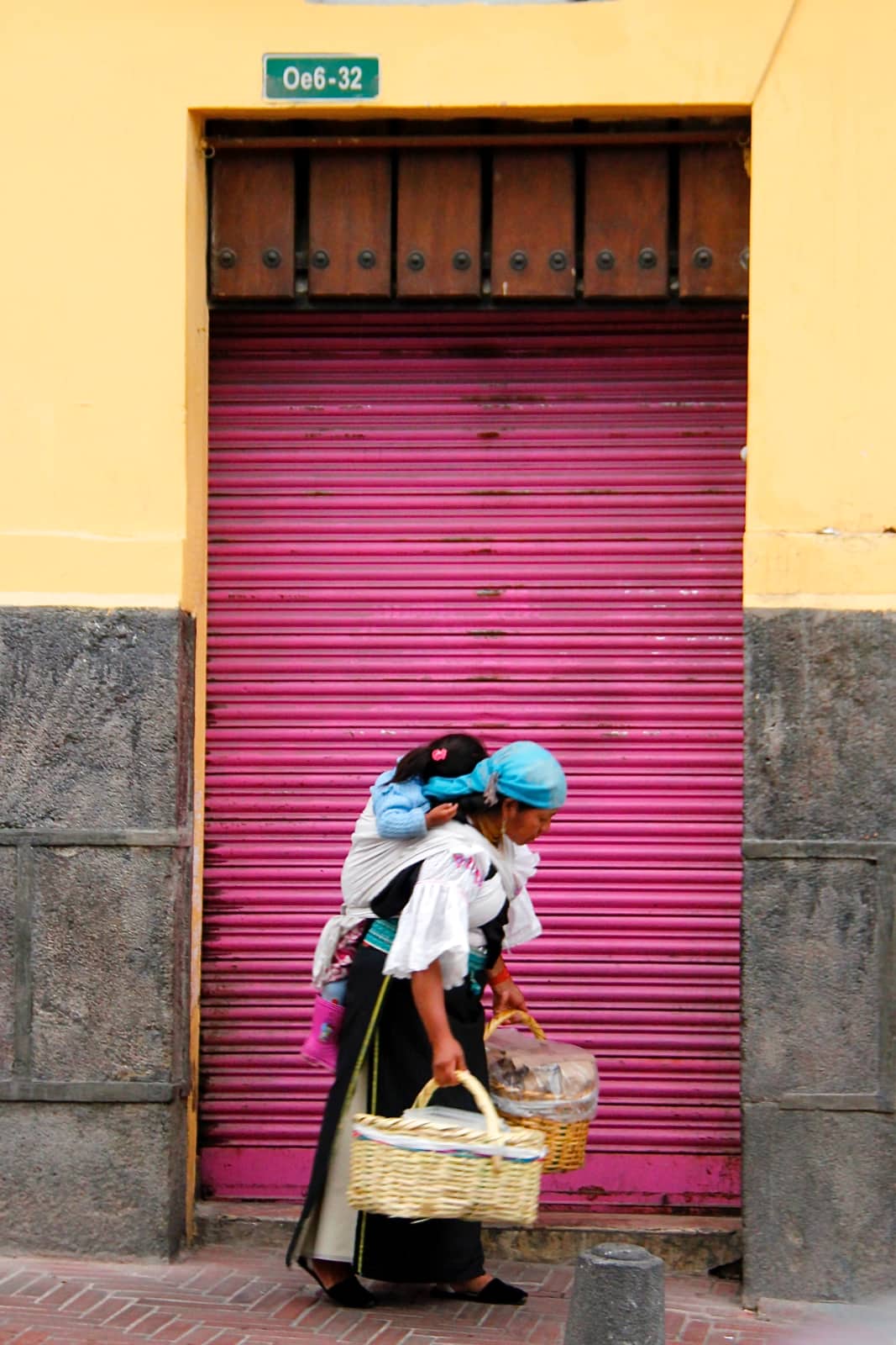 Local woman carrying child in basket