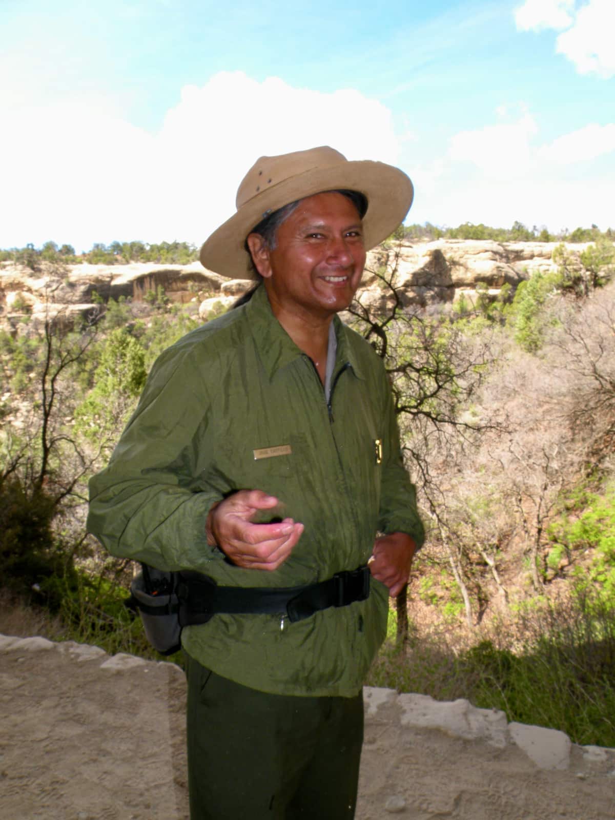 Male ranger in green jacket smiling