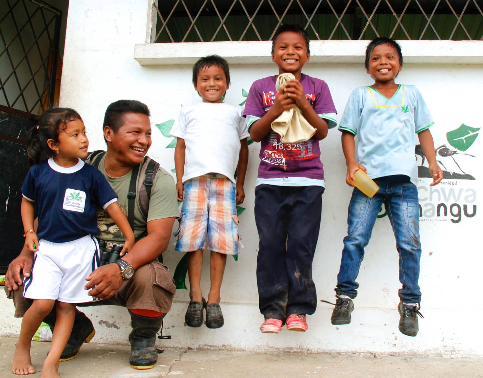 Man and children smiling for camera