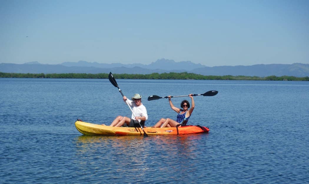 Man and woman kayaking on ocean