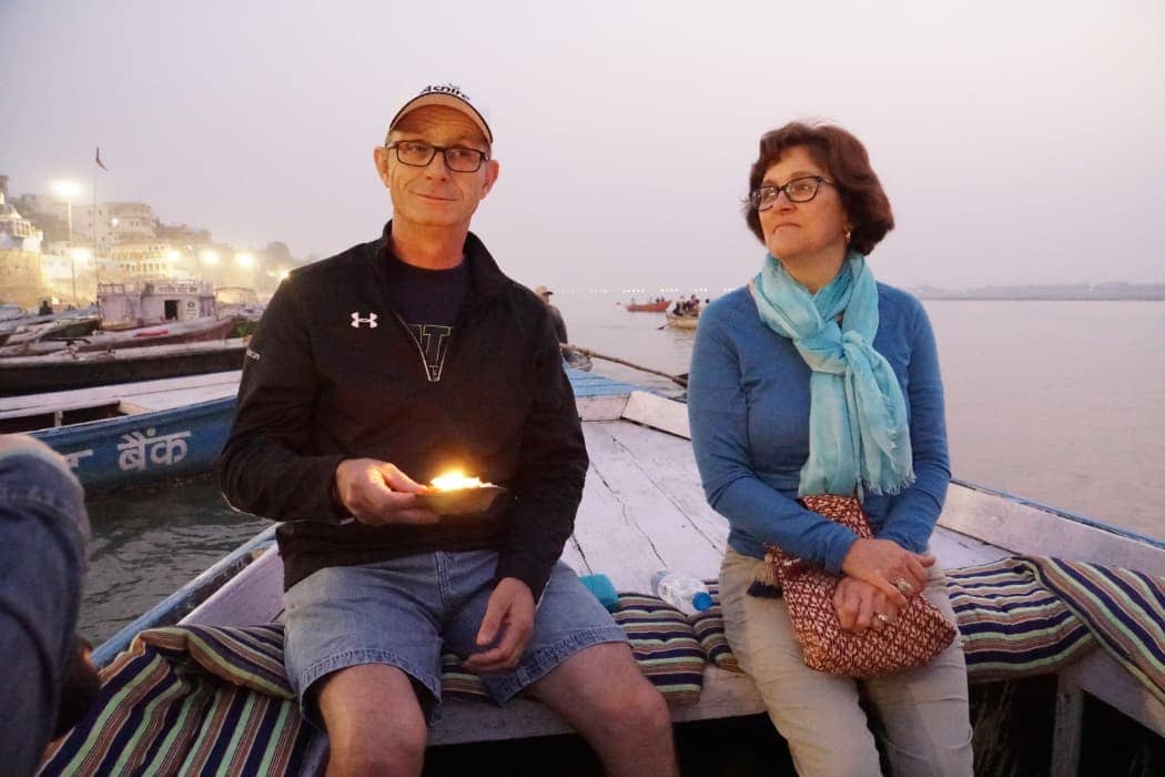 Man and woman sitting on boat on the Ganges river