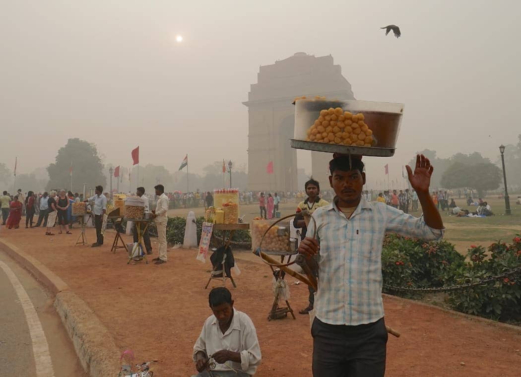 Man carrying food items on head